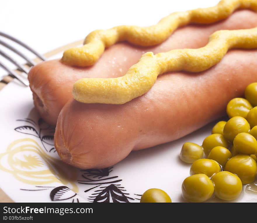 Plate with sausage, mustard and green peas. Plate with sausage, mustard and green peas