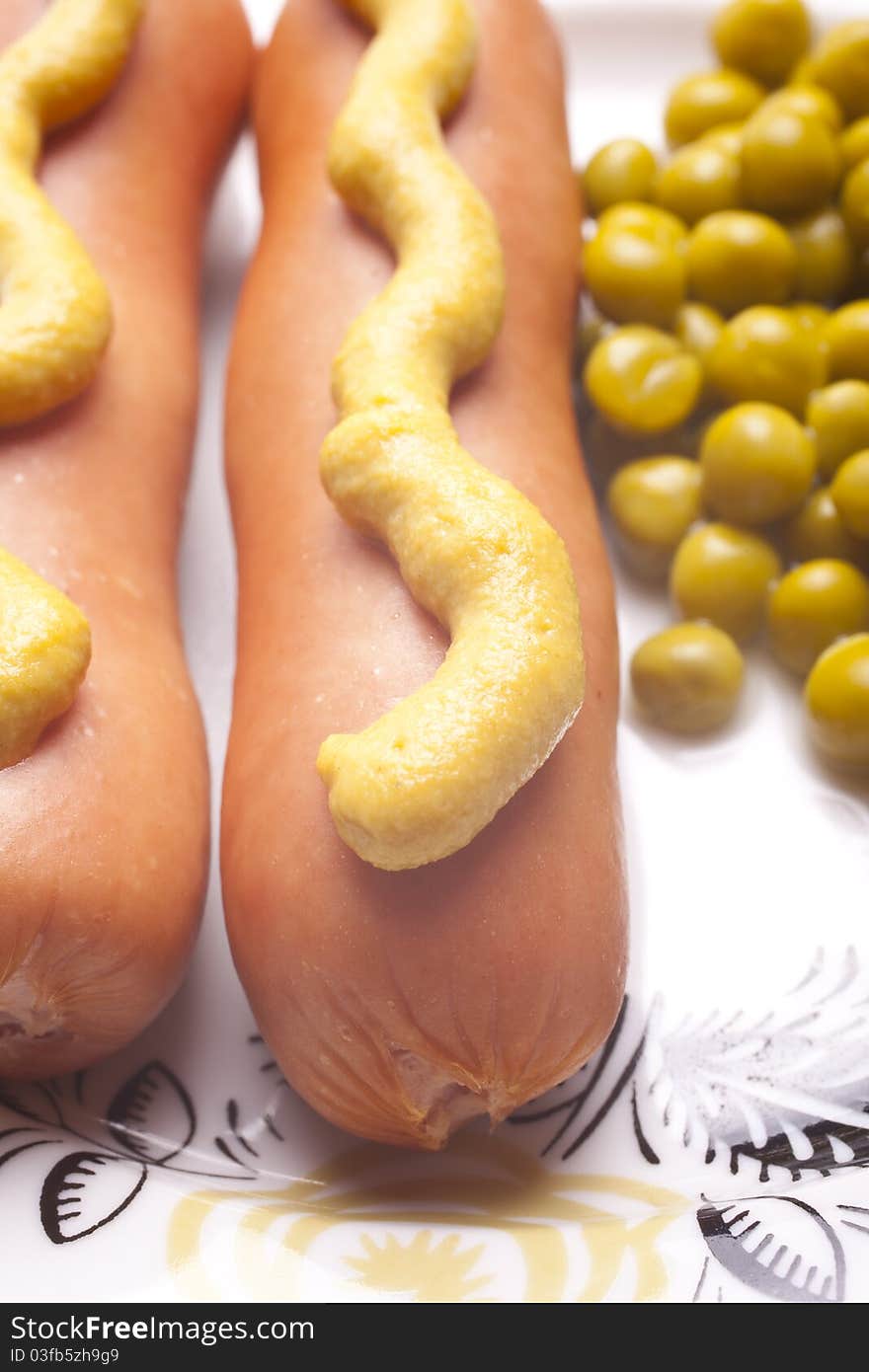 Plate with sausage, mustard and green peas. Plate with sausage, mustard and green peas