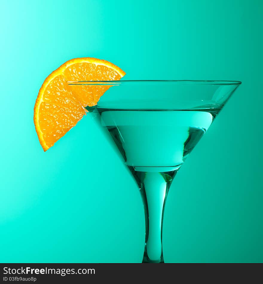 Glass With Juice And Lemon On The Green Background