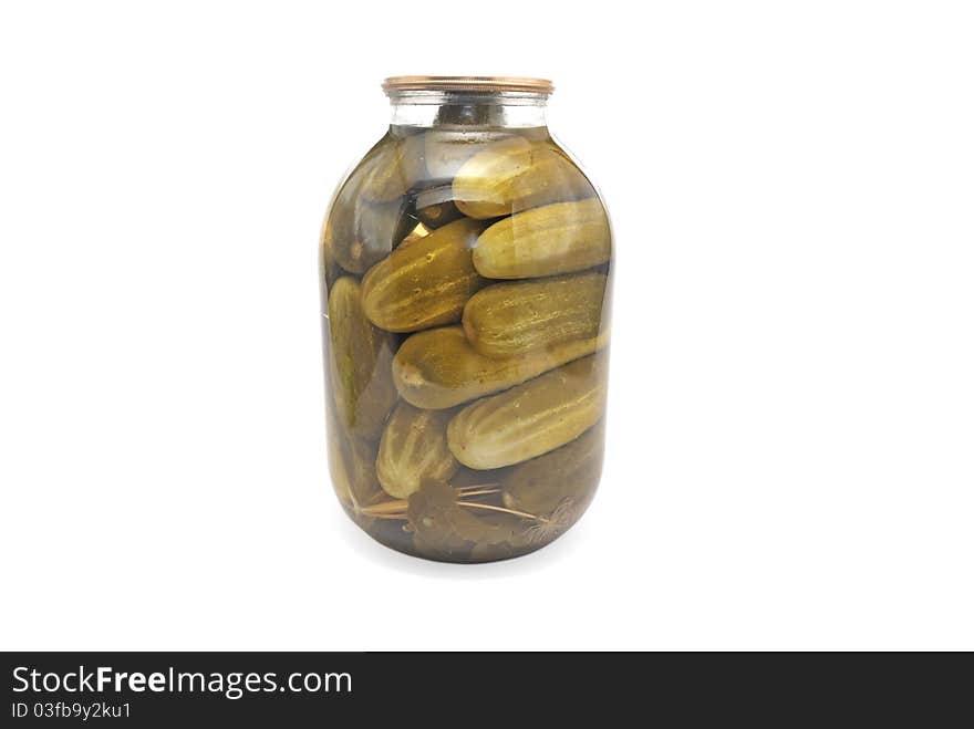 Canned cucumber in a glass jar. Pickles.