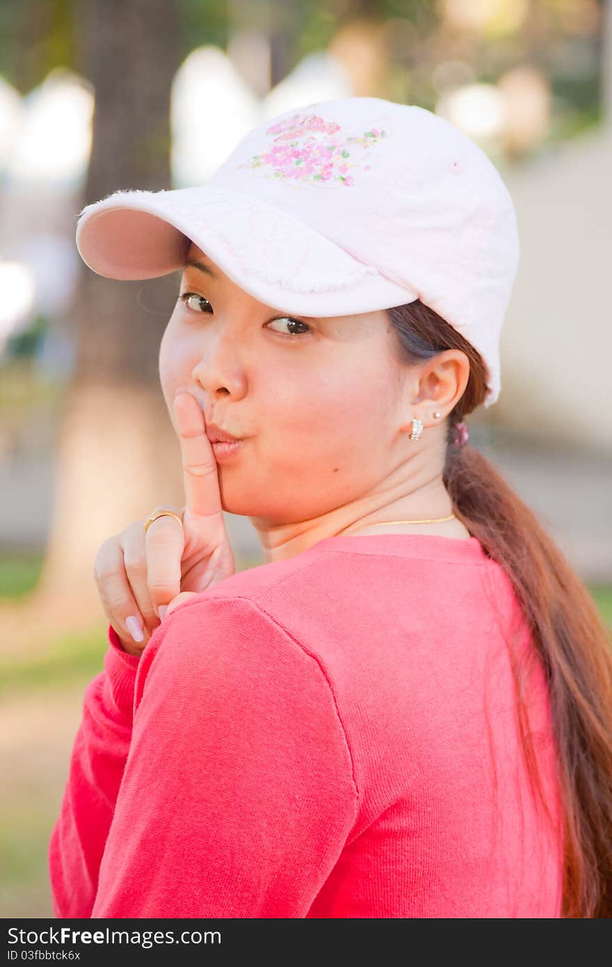 Young woman turn around and concede at the mouth of some symptoms with little smile. Young woman turn around and concede at the mouth of some symptoms with little smile