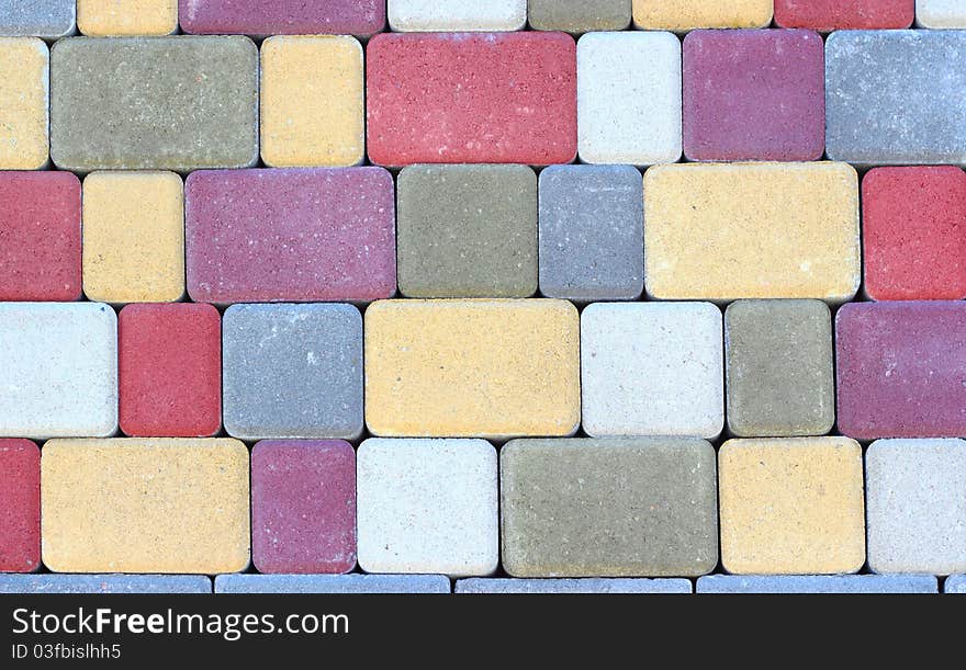 Artificial multi-colored rectangular stone close up. Artificial multi-colored rectangular stone close up