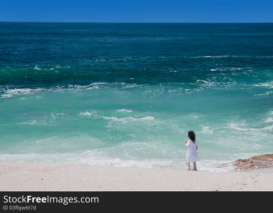 Girl standing on the tropical beach