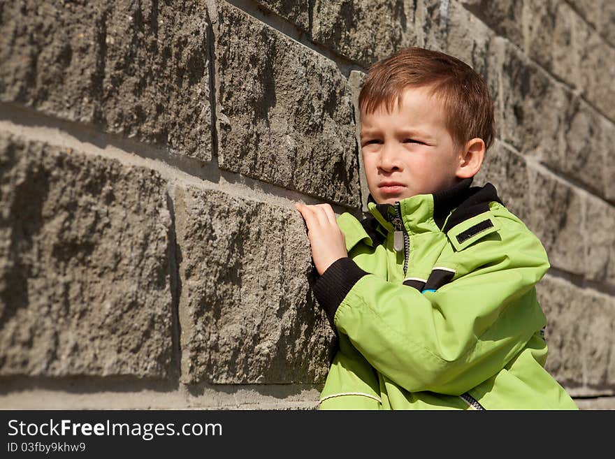 Portrait Of  Boy About  Gray Wall