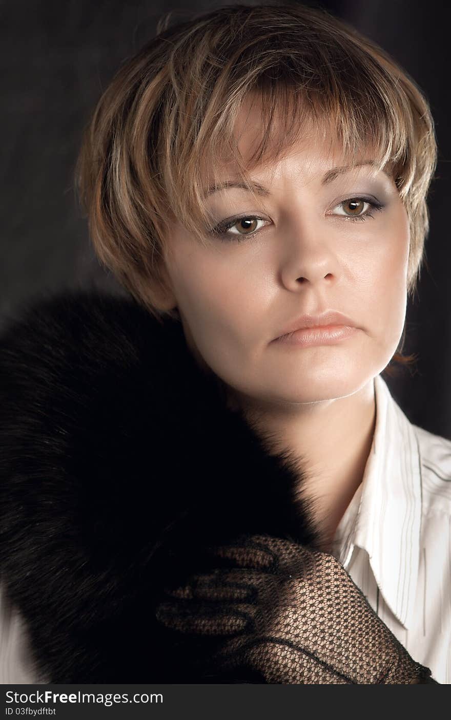 Portrait Of Woman Wearing Gloves And  Black Fur