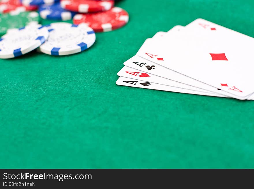 Pocker chips and playing cards on green table. Pocker chips and playing cards on green table