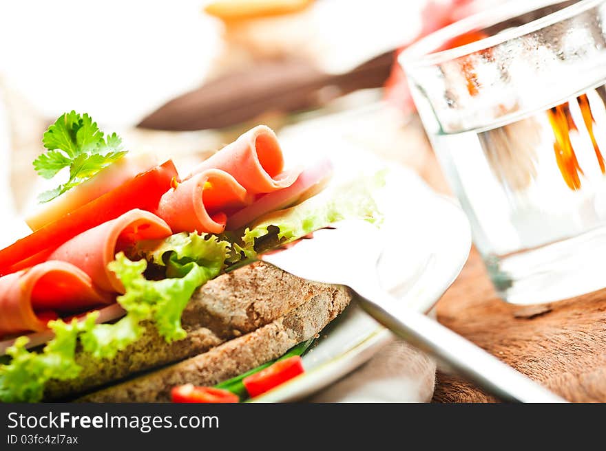 Brown bread with chili sausage slices green salad tomato and egg. Brown bread with chili sausage slices green salad tomato and egg