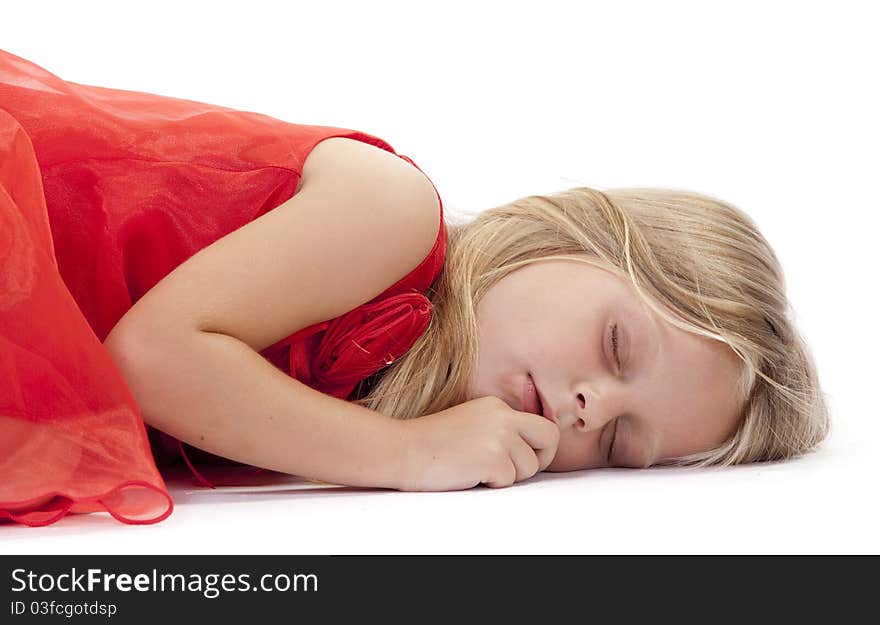 Little girl sleeping in a red dress on a white background. Little girl sleeping in a red dress on a white background.