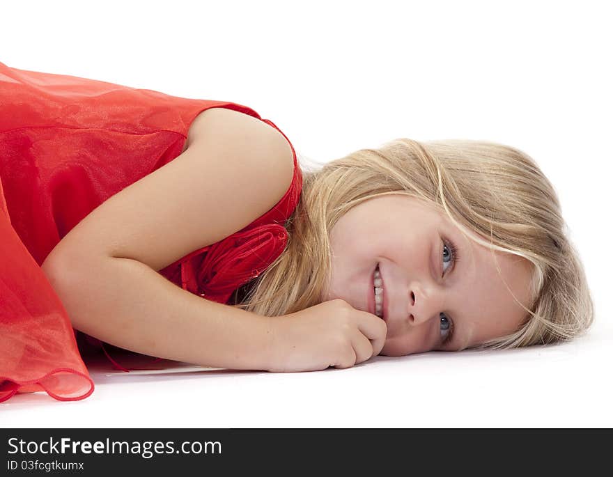 Little girl lying down in a red dress on a white background. Little girl lying down in a red dress on a white background.