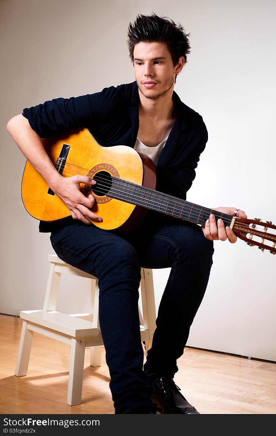 Young man playing a guitar. Young man playing a guitar