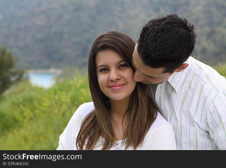 Close-up of man kissing and snuggling attractive woman. Close-up of man kissing and snuggling attractive woman