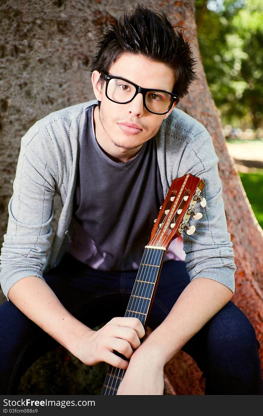 Young man playing a guitar. Young man playing a guitar