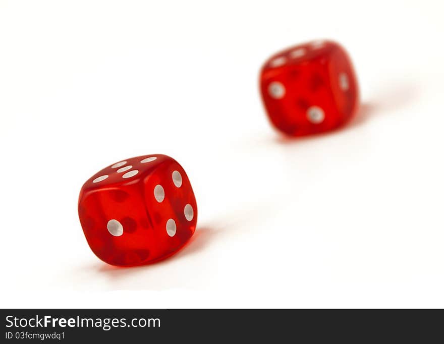 Two red, glossy, transparent dices.