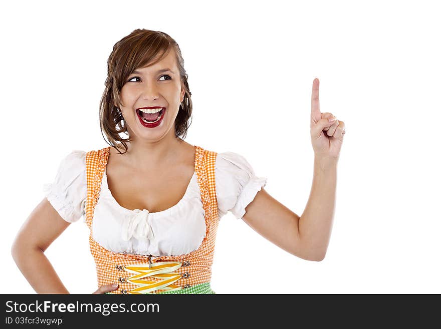 Beautiful smiling Girl in dirndl points with finger up to ad space.Isolated on white background. Beautiful smiling Girl in dirndl points with finger up to ad space.Isolated on white background.