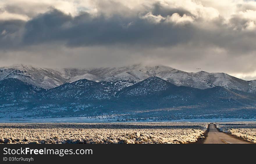 A photograph of beautiful mountains with some very stormy clouds. A photograph of beautiful mountains with some very stormy clouds.