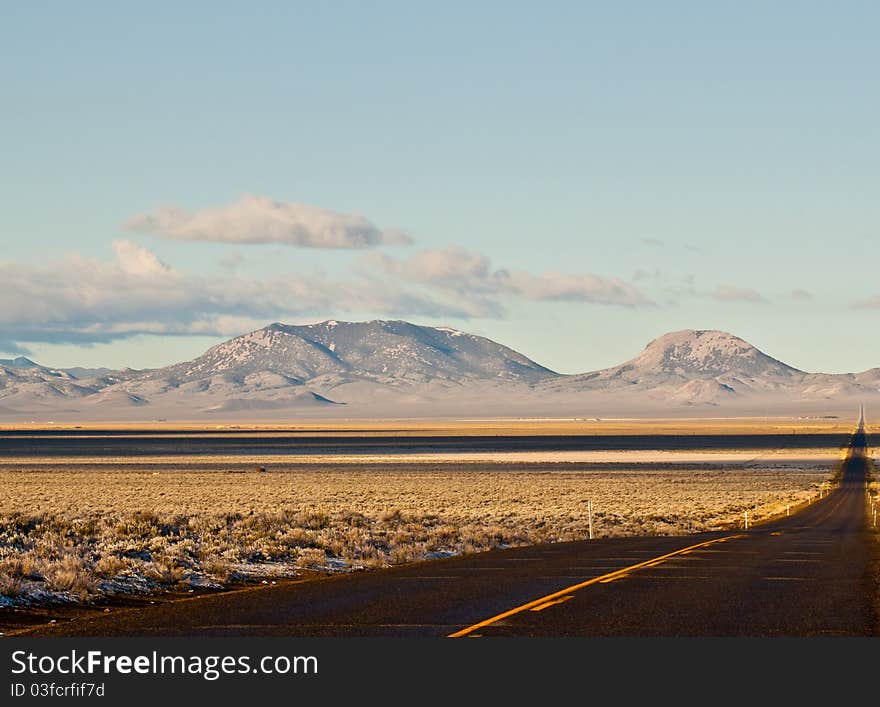 A photograph of a frontage road in Austing NV.  The mountiain is shaped nicely. A photograph of a frontage road in Austing NV.  The mountiain is shaped nicely.