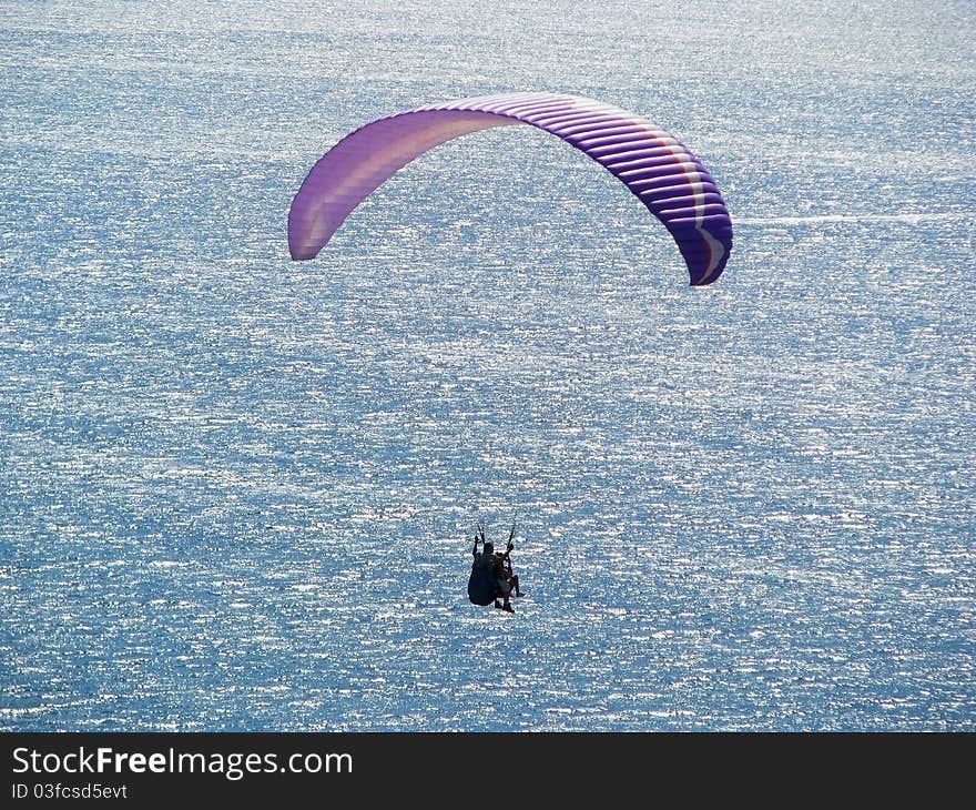 Paraplane flight over the sea. Educational flight on a paraglider. Paraplane flight over the sea. Educational flight on a paraglider.