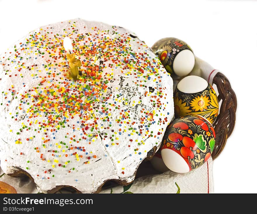 Easter cake with candle and eggs on a background