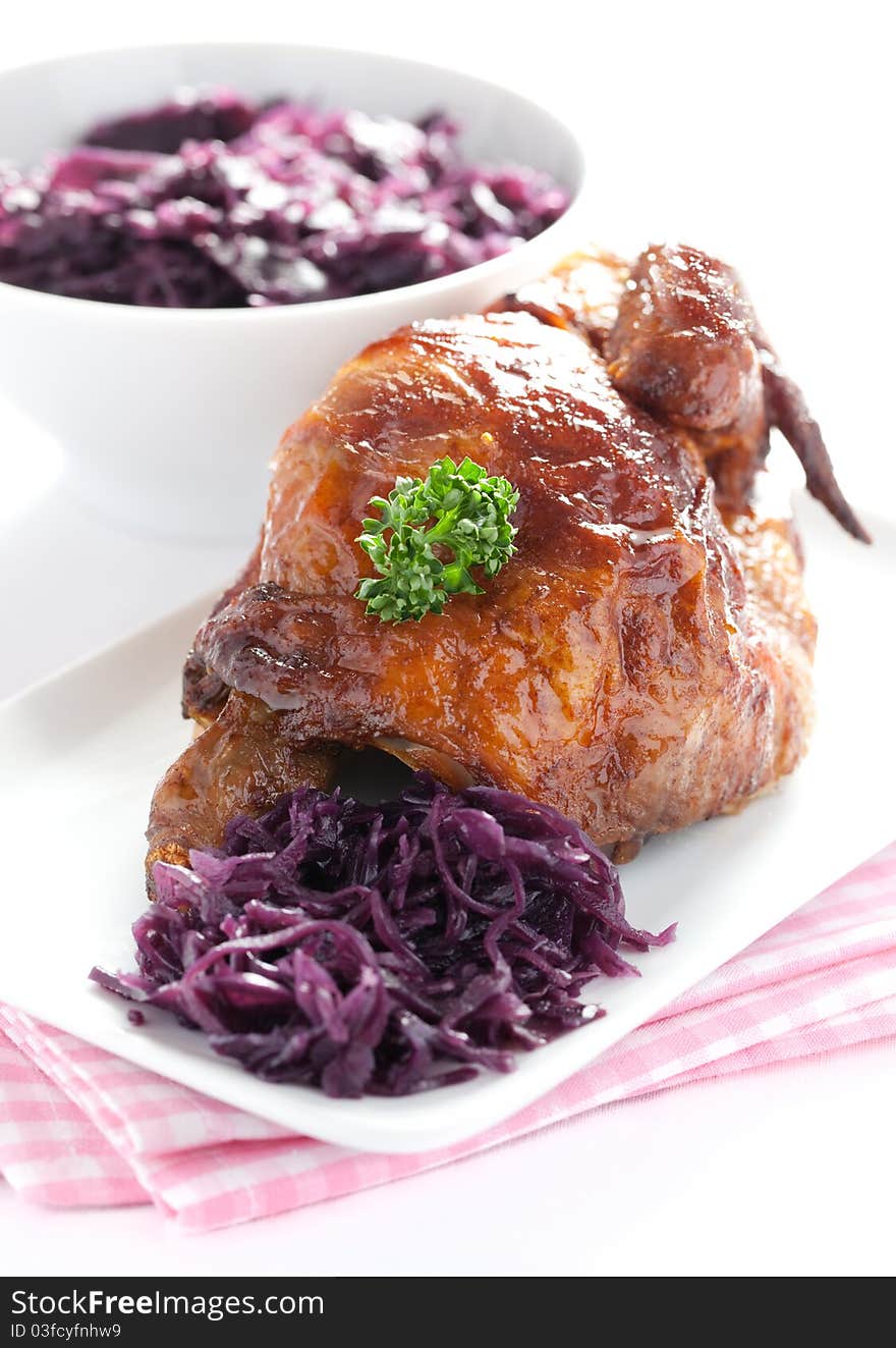 Fresh fried chicken and red cabbage served. Fresh fried chicken and red cabbage served