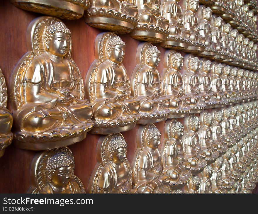 Many Small Buddha Statue On The Wall