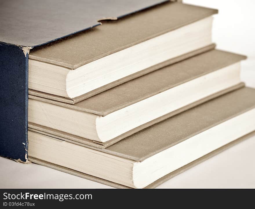 Three grey books in the box  on material background