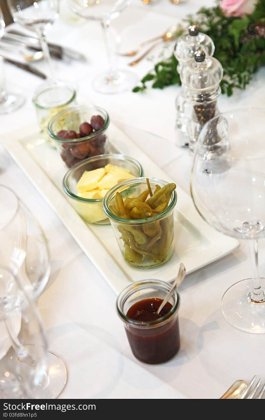 Tapas and appetizers, olives and butter on the table - vertical. Tapas and appetizers, olives and butter on the table - vertical