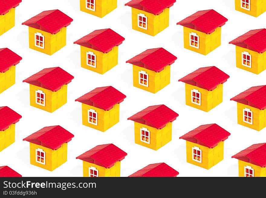 Toy houses lined up in rows on a white background. Concept, texture. Toy houses lined up in rows on a white background. Concept, texture