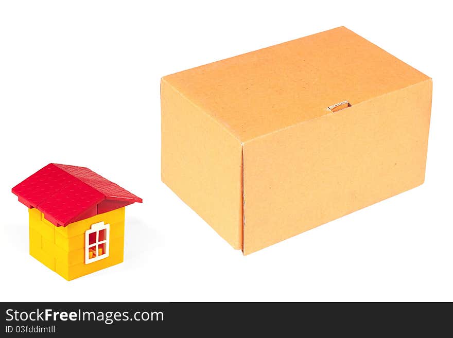 Cardboard box and a toy house with a white background. Cardboard box and a toy house with a white background