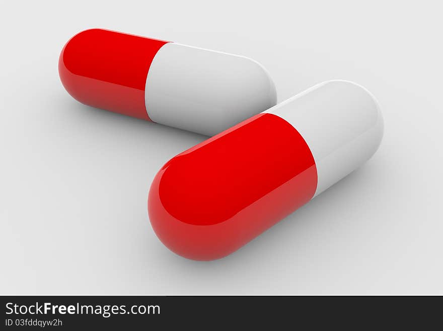 Two red and white pills on white surface.