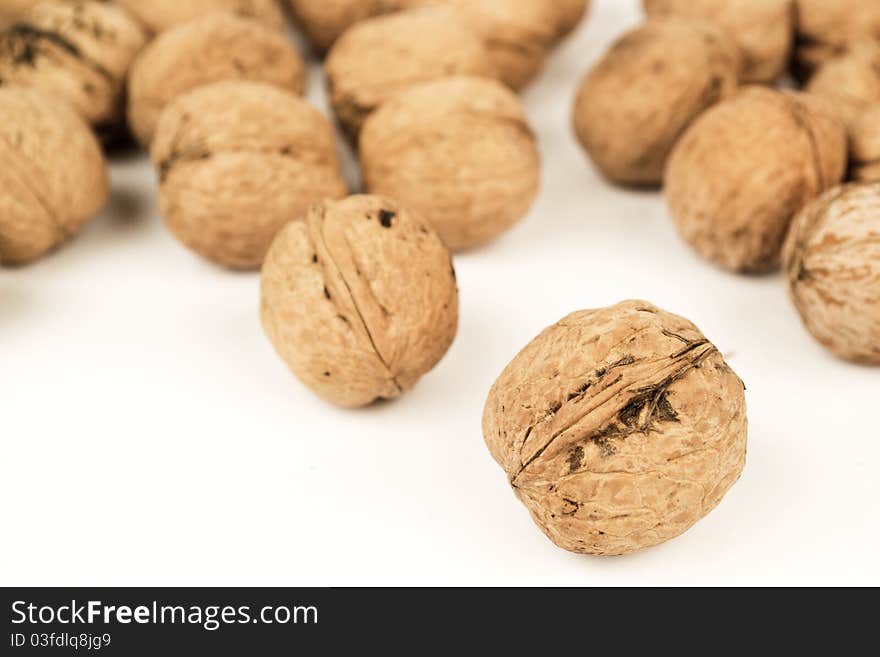 Walnuts on white, close up. Walnuts on white, close up