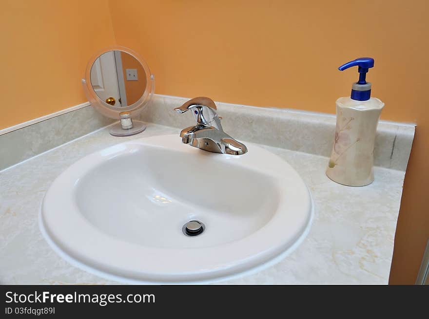 Luxurious white wash basin with mirror and hand soap. Luxurious white wash basin with mirror and hand soap.