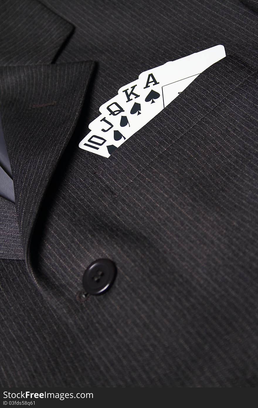 Royal straight flush with playing cards in gray suit pocket. Royal straight flush with playing cards in gray suit pocket