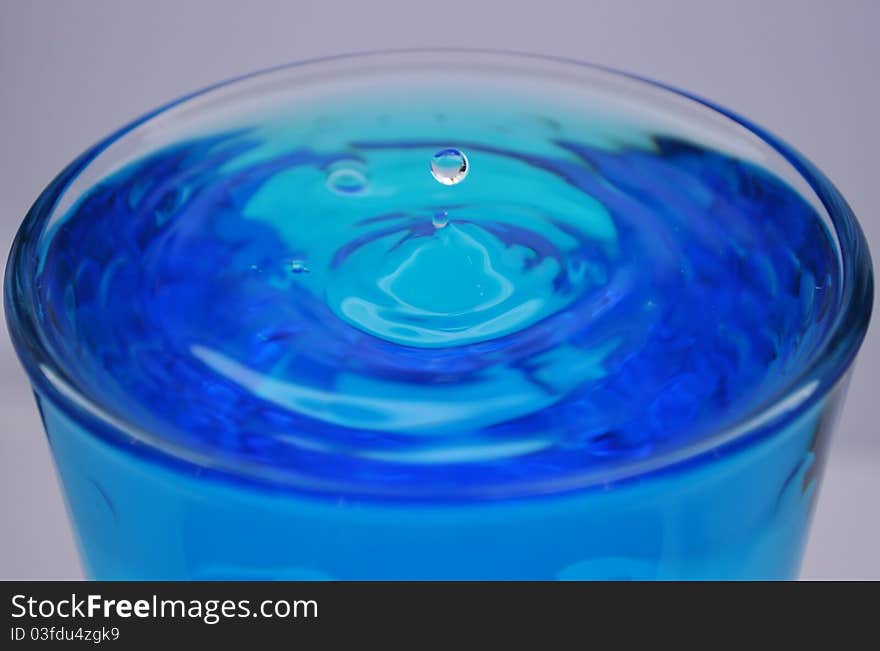 Water drop in a cup