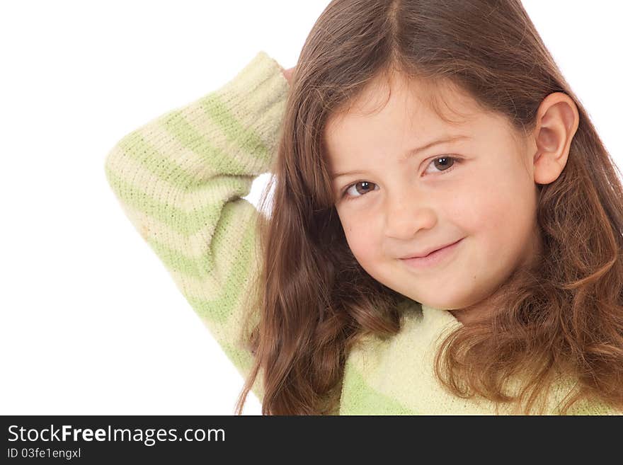 Young girl in green striped jumper jersey with arm behind head and smiling. Young girl in green striped jumper jersey with arm behind head and smiling