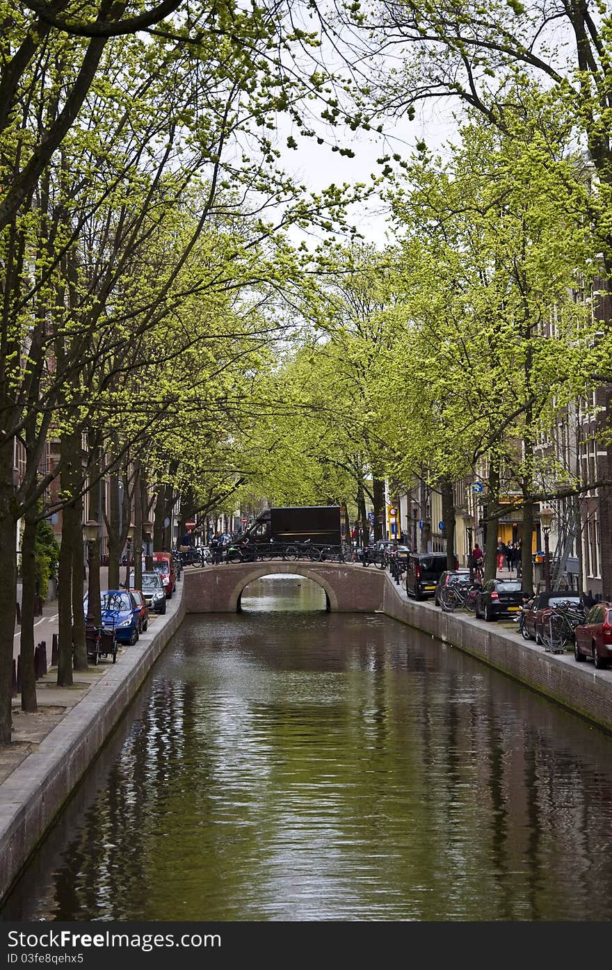 Canal in Amsterdam. Spring cityscape. Bicycles are on the waterfront.