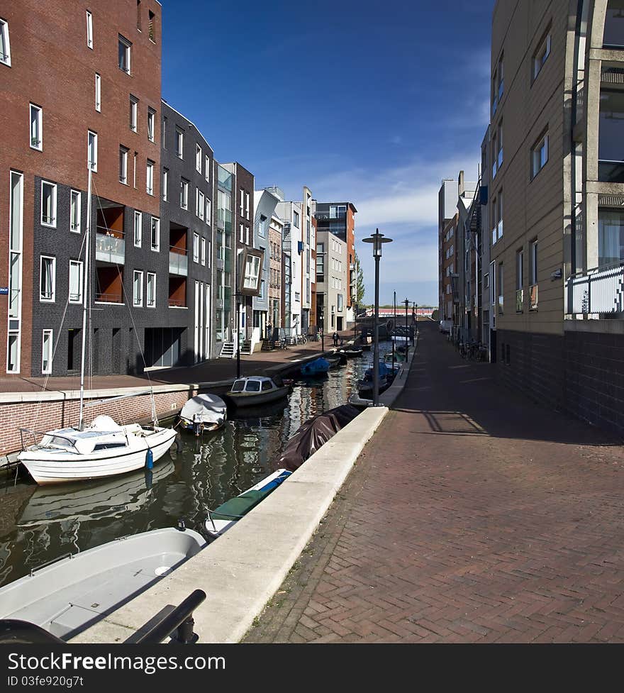 Modern residential houses on the canal in Amsterdam. Spring cityscape.