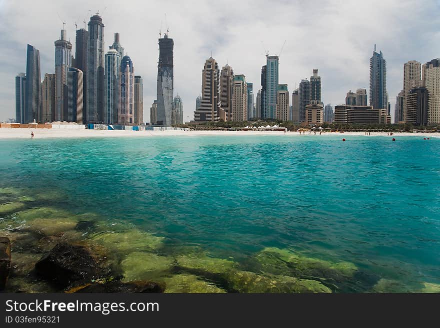 Beautiful sea bay on the background of the modern city.