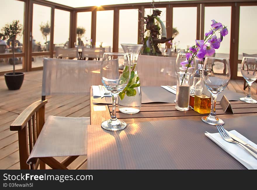 Beach terrace with table by sundown. Beach terrace with table by sundown