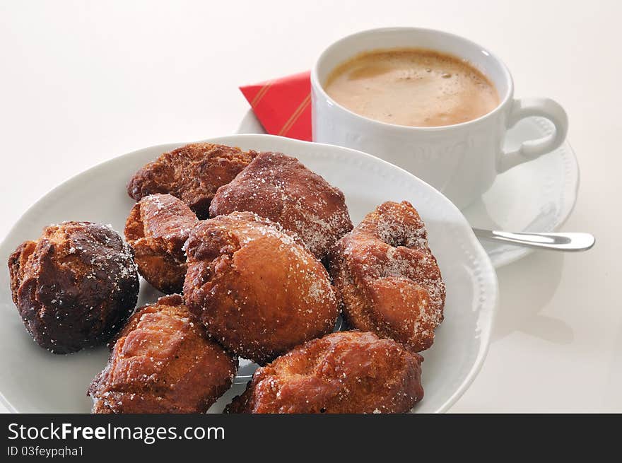 Traditional spanish fritters and a white coffee