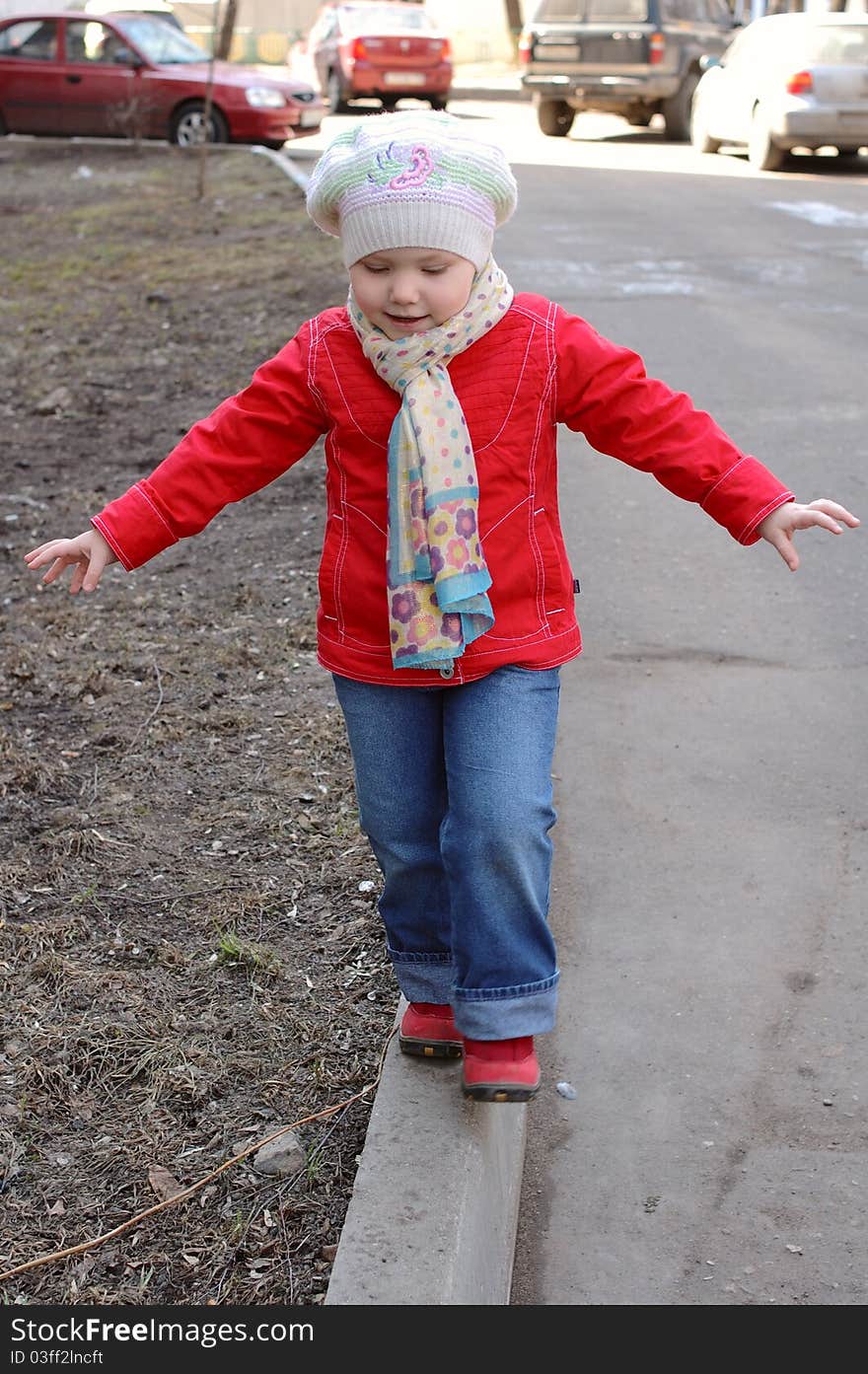 Pretty little girl walking on the street. Pretty little girl walking on the street.