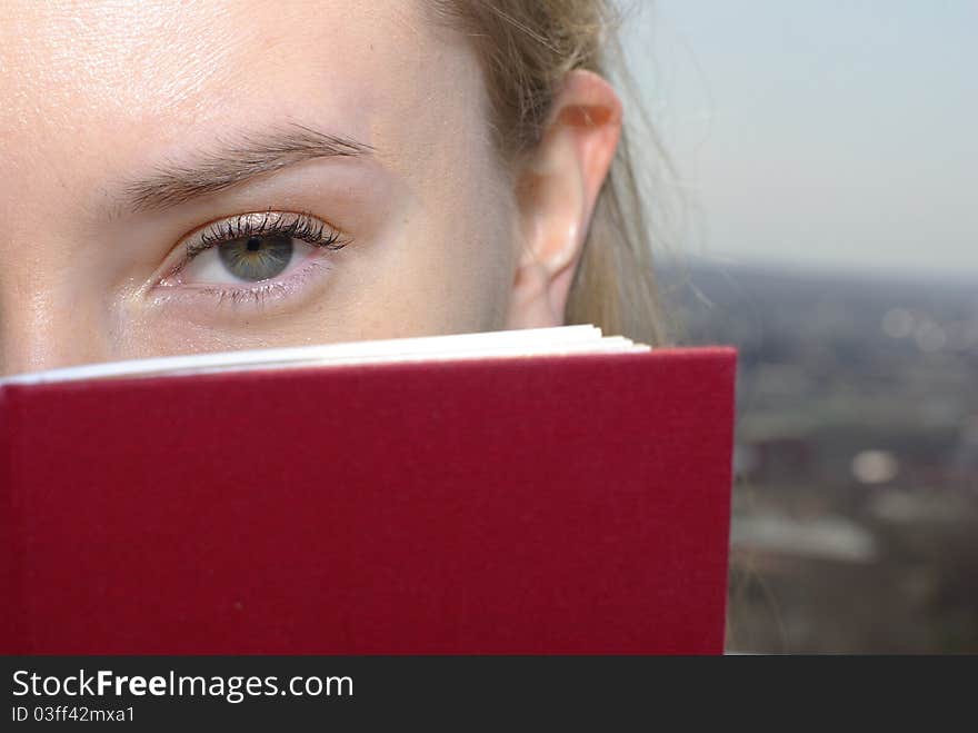 Young caucasian girl with a red book