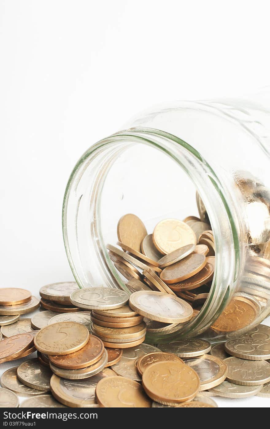 Coins in jar on white background. Coins in jar on white background