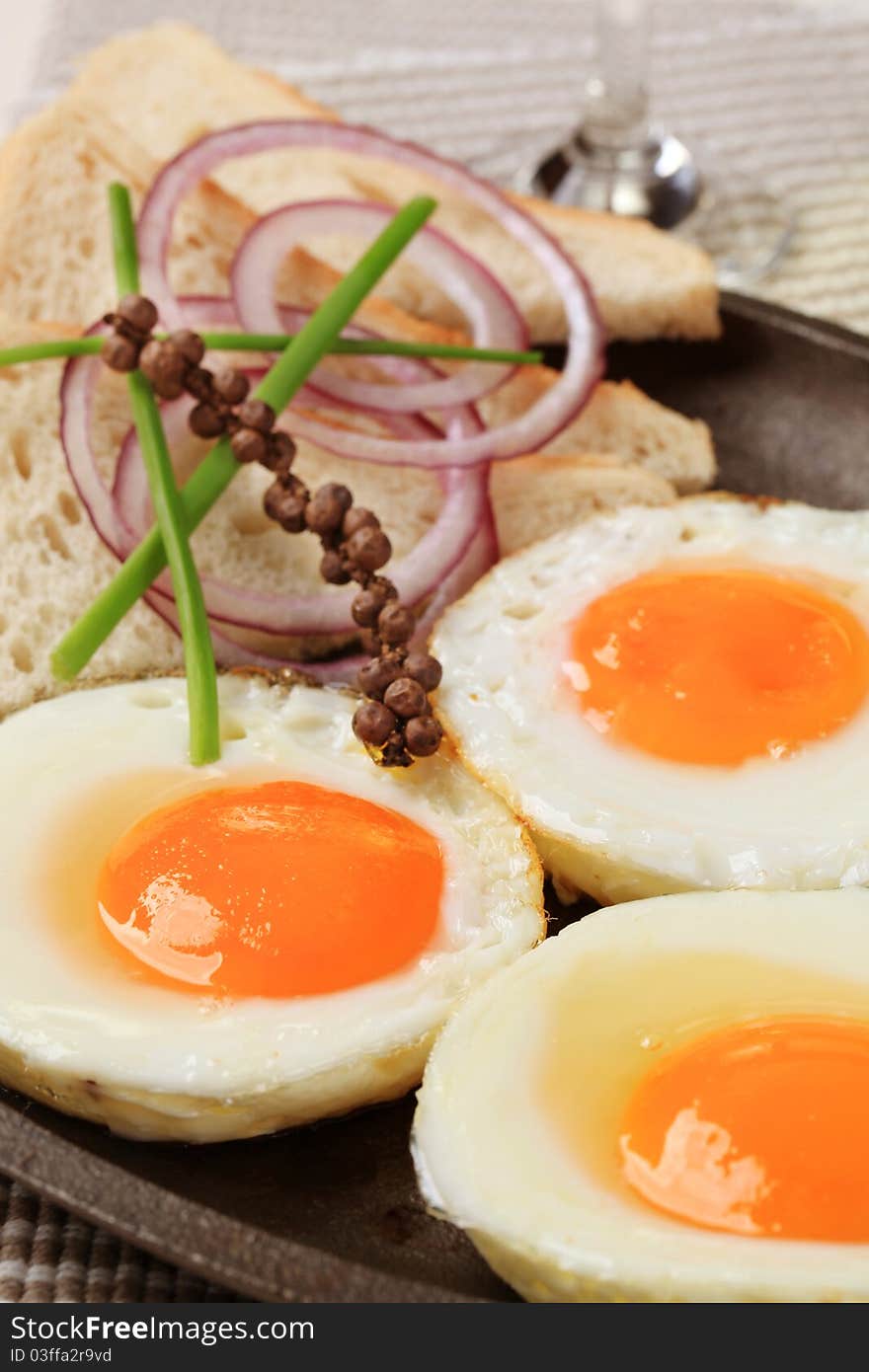 Fried eggs and white bread on a skillet. Fried eggs and white bread on a skillet