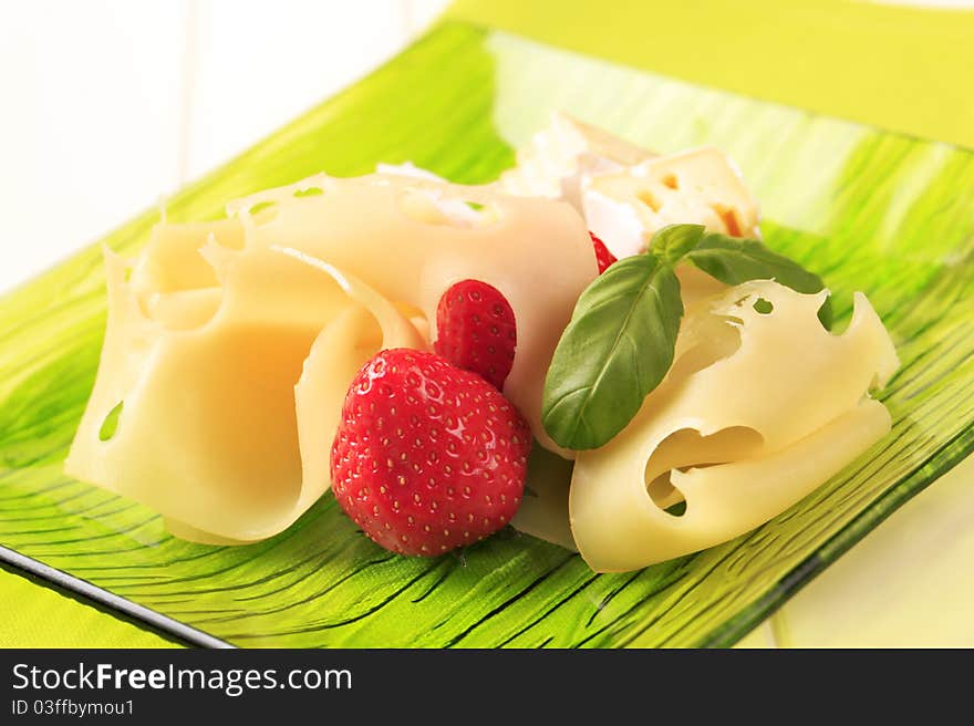 Cheese and fresh strawberries on a plate. Cheese and fresh strawberries on a plate