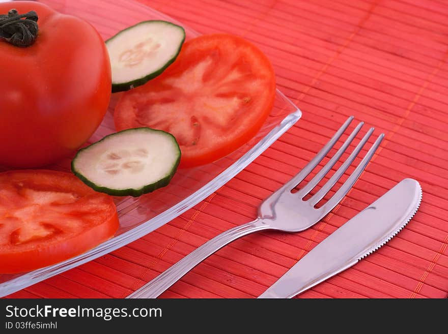 Salad made of fresh tomato and cucumber served on glass plate