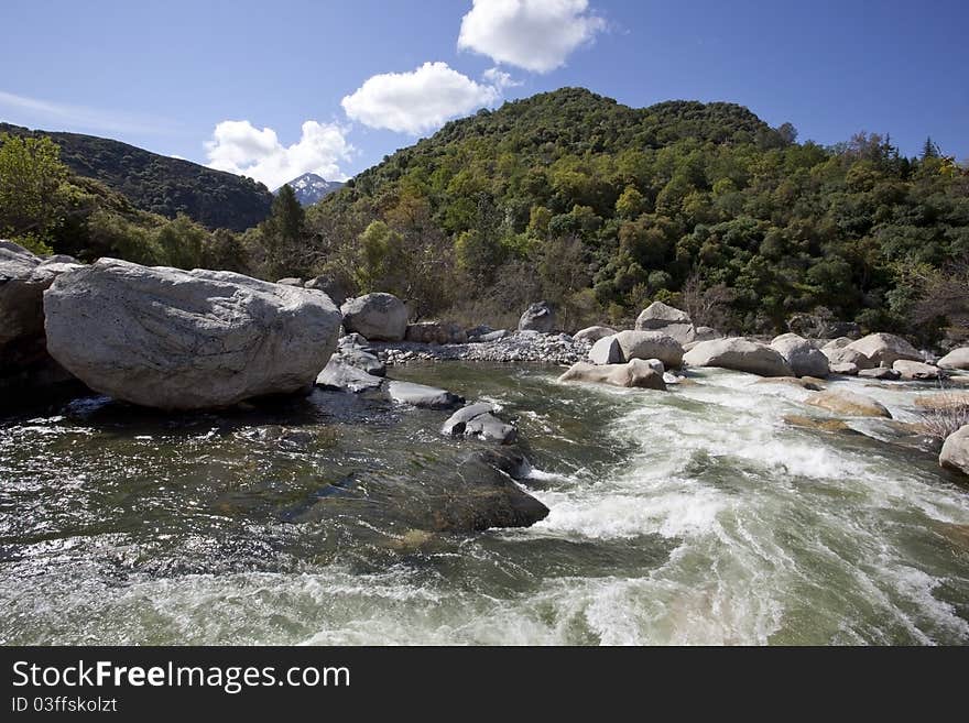 Mountain quick spring river at sunny day