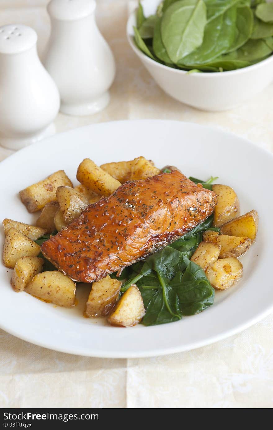 Spice-crusted salmon with roast potatoes and spinach. Spice-crusted salmon with roast potatoes and spinach