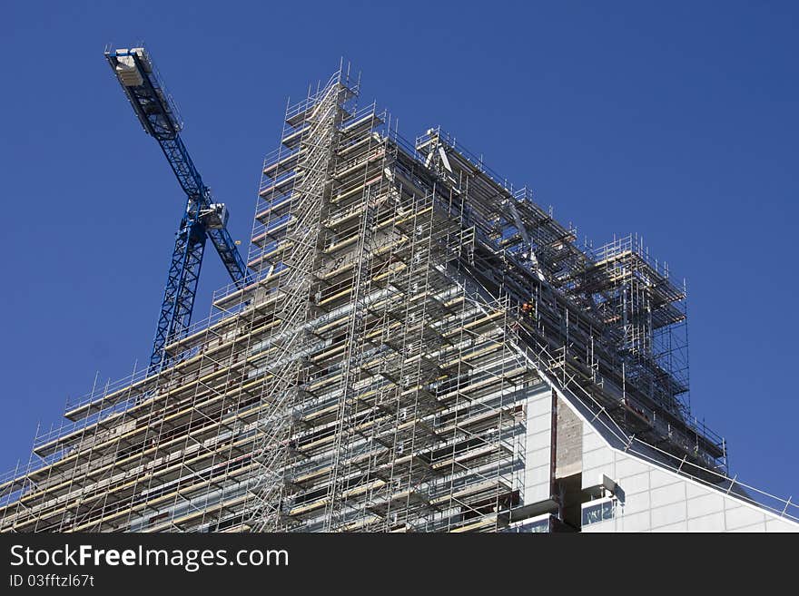 Construction of new building with one crane in background