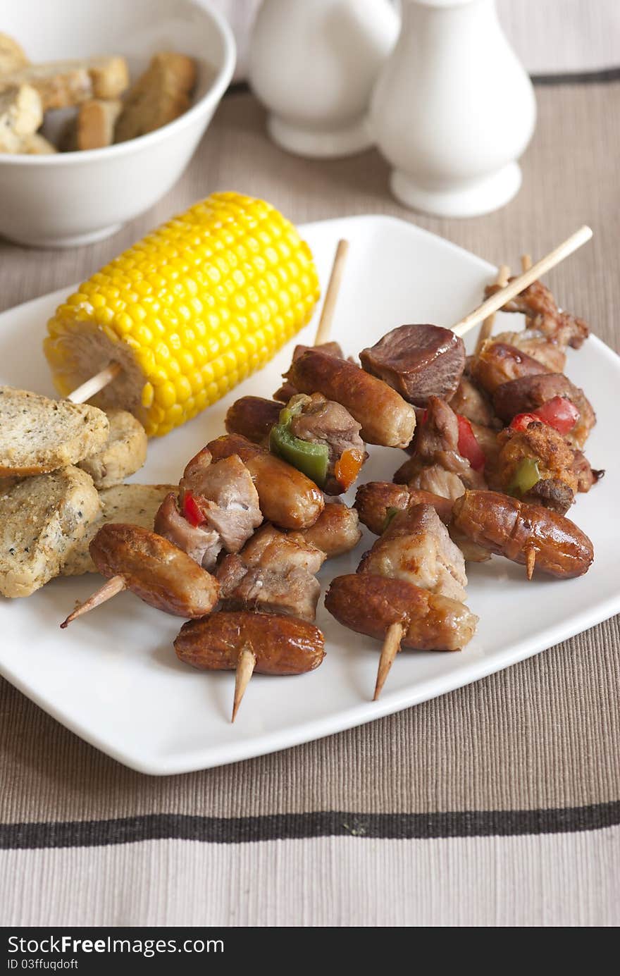 Smoky sausage kebabs with corn on the cob