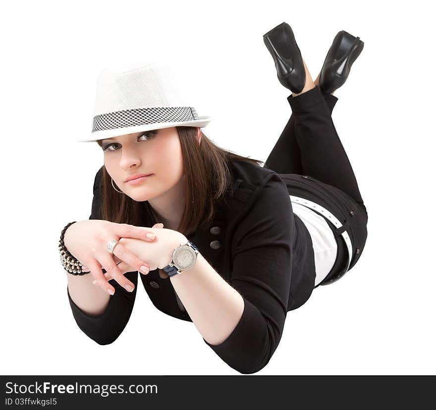 Pretty girl in the hat laying down over white background.